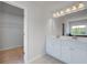 Bright bathroom with dual vanity, white cabinets, and a view to a walk-in closet at 17 Camellia Dr, Fairburn, GA 30213