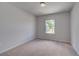 Neutral bedroom with a window bringing in natural light and plush carpet at 17 Camellia Dr, Fairburn, GA 30213