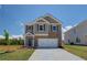Charming two-story home with grey siding, brick accents, blue shutters and a well-manicured lawn at 17 Camellia Dr, Fairburn, GA 30213