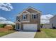 Beautiful two-story home with brick and siding, a two-car garage, and a paved driveway at 17 Camellia Dr, Fairburn, GA 30213
