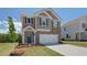 Lovely home with gray siding, brick accents, a two-car garage, and a freshly landscaped yard at 17 Camellia Dr, Fairburn, GA 30213