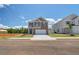 Inviting two-story home featuring brick accents, a two-car garage, and professionally landscaped front yard at 17 Camellia Dr, Fairburn, GA 30213