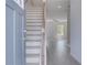 Bright foyer with light gray plank flooring, a staircase, and a view into the open-concept living area at 17 Camellia Dr, Fairburn, GA 30213
