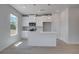 Stylish kitchen with white cabinets, an island with pendant lighting, stainless steel appliances, and hardwood flooring at 17 Camellia Dr, Fairburn, GA 30213