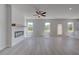 Spacious living room featuring an electric fireplace, modern gray plank flooring, and lots of natural light at 17 Camellia Dr, Fairburn, GA 30213