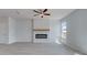 Bright living room with gray walls, plank flooring, an electric fireplace, and a large window at 17 Camellia Dr, Fairburn, GA 30213
