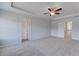 Large main bedroom boasts a tray ceiling, ceiling fan, plush carpet, and two doorways at 17 Camellia Dr, Fairburn, GA 30213