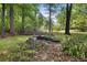 Private backyard area with a rock feature and wooded surroundings at 2035 Stilesboro Nw Dr, Kennesaw, GA 30152