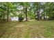 Expansive backyard featuring mature trees, providing shade and a serene outdoor space at 2035 Stilesboro Nw Dr, Kennesaw, GA 30152