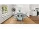 Bright dining area with a table set for four, natural light, and hardwood floors at 2035 Stilesboro Nw Dr, Kennesaw, GA 30152