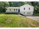 Charming two-story white home with a covered porch and a well-manicured lawn and driveway at 2035 Stilesboro Nw Dr, Kennesaw, GA 30152