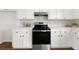 Bright kitchen with white cabinets, stainless steel oven, and ample counter space at 2035 Stilesboro Nw Dr, Kennesaw, GA 30152