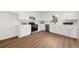 Modern kitchen with white cabinets, stainless steel appliances, and hardwood floors at 2035 Stilesboro Nw Dr, Kennesaw, GA 30152