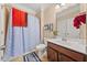 Bathroom featuring a shower with curtain, a toilet, and vanity with a dark wood cabinet at 4060 Brumby Ln, Cumming, GA 30041