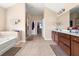 Large bathroom featuring a shower, bathtub, double sink vanity, and tile floors at 4060 Brumby Ln, Cumming, GA 30041