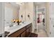 Well-lit bathroom featuring a double sink vanity, fresh flowers, and neutral color palette at 4060 Brumby Ln, Cumming, GA 30041