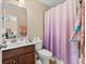 Bathroom featuring a shower with curtain, a toilet, and vanity with a dark wood cabinet at 4060 Brumby Ln, Cumming, GA 30041