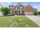 Charming two-story brick home with a well-manicured lawn and a two-car garage at 4060 Brumby Ln, Cumming, GA 30041