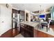 Open-concept kitchen with a central island, stainless steel appliances, and a view of the living room at 4060 Brumby Ln, Cumming, GA 30041