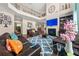 Elegant living room featuring high ceilings, a fireplace, and a cozy seating area with leather furniture at 4060 Brumby Ln, Cumming, GA 30041