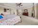 Spacious main bedroom featuring a ceiling fan, carpet floors, and ensuite bathroom at 4060 Brumby Ln, Cumming, GA 30041