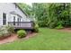 Expansive backyard featuring a wooden deck, lush lawn, and mature trees, perfect for outdoor enjoyment at 511 Pine Springs Se Trl, Marietta, GA 30067