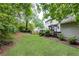A well-maintained backyard with a large lawn, privacy fence, and mature trees providing a tranquil setting at 511 Pine Springs Se Trl, Marietta, GA 30067