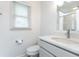 Bright bathroom with a large window, white vanity, and modern toilet at 511 Pine Springs Se Trl, Marietta, GA 30067
