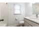 Well lit bathroom featuring tub-shower combo, vanity, and window at 511 Pine Springs Se Trl, Marietta, GA 30067