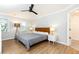 Bedroom with ceiling fan, bedside tables, lamps, and view to bathroom at 511 Pine Springs Se Trl, Marietta, GA 30067