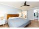 Bedroom with ceiling fan, bedside tables, and view to bathroom and closet at 511 Pine Springs Se Trl, Marietta, GA 30067