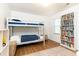 bedroom with a bunk bed, hardwood floors, rug, and a bookshelf at 511 Pine Springs Se Trl, Marietta, GA 30067