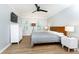 Bedroom with hardwood floor, ceiling fan, TV, windows, and white dresser at 511 Pine Springs Se Trl, Marietta, GA 30067