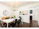 Dining room with black chairs, white table, and modern light fixture at 511 Pine Springs Se Trl, Marietta, GA 30067