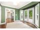 Dining area with green walls, French doors to deck, and wood floors at 511 Pine Springs Se Trl, Marietta, GA 30067