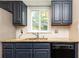 Kitchen featuring navy cabinets, granite countertops, and stainless steel appliances at 511 Pine Springs Se Trl, Marietta, GA 30067