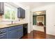 Kitchen with navy cabinets, granite countertops, and stainless steel appliances at 511 Pine Springs Se Trl, Marietta, GA 30067