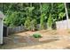 This backyard features a privacy fence, storage building and mature trees at 1132 Britley Park Ln Ln, Woodstock, GA 30189