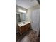Bathroom featuring tile floors, a sink with wood cabinets, and a large mirror at 1132 Britley Park Ln Ln, Woodstock, GA 30189