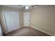 Bedroom with neutral walls, carpet floors, and a double door closet at 1132 Britley Park Ln Ln, Woodstock, GA 30189