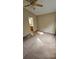 Neutral bedroom with a ceiling fan, carpet, and access to an attached bathroom at 1132 Britley Park Ln Ln, Woodstock, GA 30189