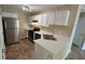 Galley style kitchen with stainless steel appliances, white cabinetry, and quartz countertops at 1132 Britley Park Ln Ln, Woodstock, GA 30189