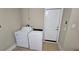 Laundry room with a washer and dryer and a white door at 1132 Britley Park Ln Ln, Woodstock, GA 30189