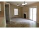 Living room with fan, fireplace, tile/carpet flooring, neutral walls and sliding glass door to patio at 1132 Britley Park Ln Ln, Woodstock, GA 30189