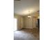 Spacious living room with neutral walls, chandelier, and visible tile/carpet flooring at 1132 Britley Park Ln Ln, Woodstock, GA 30189
