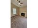 Living room featuring a ceiling fan, fireplace, neutral walls, and plush carpet flooring at 1132 Britley Park Ln Ln, Woodstock, GA 30189