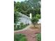 The side yard features mature landscaping, a walkway and privacy from neighbors at 1132 Britley Park Ln Ln, Woodstock, GA 30189