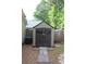 Durable storage shed in backyard with double doors and matching trim, offering ample storage at 1132 Britley Park Ln Ln, Woodstock, GA 30189