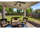 A view of the covered back patio showcasing comfortable wicker furniture and a bright blue patterned rug at 122 Grove View Rd, Woodstock, GA 30189