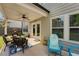 Covered back patio with outdoor seating, a ceiling fan, and easy access to the home's interior at 122 Grove View Rd, Woodstock, GA 30189